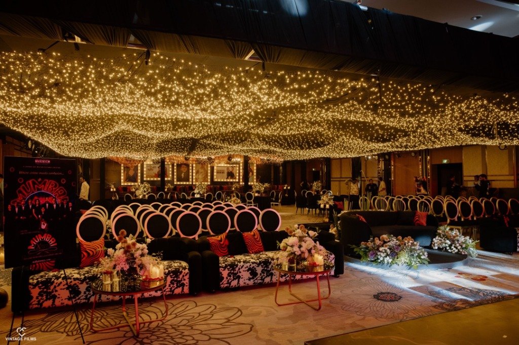 Grand reception hall with ceiling of fairy lights and elegant seating